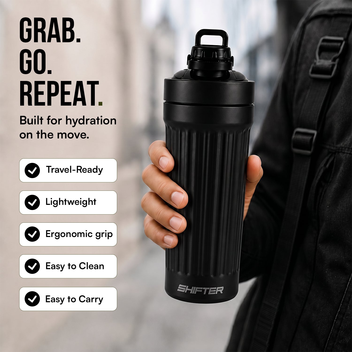 Black water bottle held by a person with features listed on the left, against a blurred outdoor background.