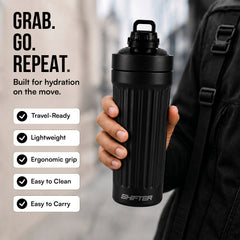 Black water bottle held by a person with features listed on the left, against a blurred outdoor background.