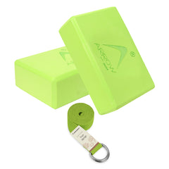 Two green yoga blocks and a yoga strap on a white background
